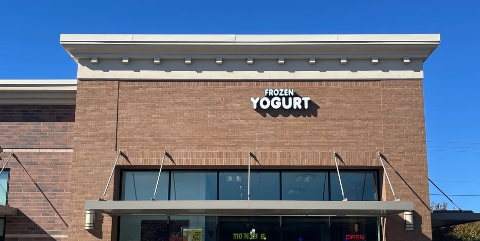 Colorful frozen yogurt cups with toppings
