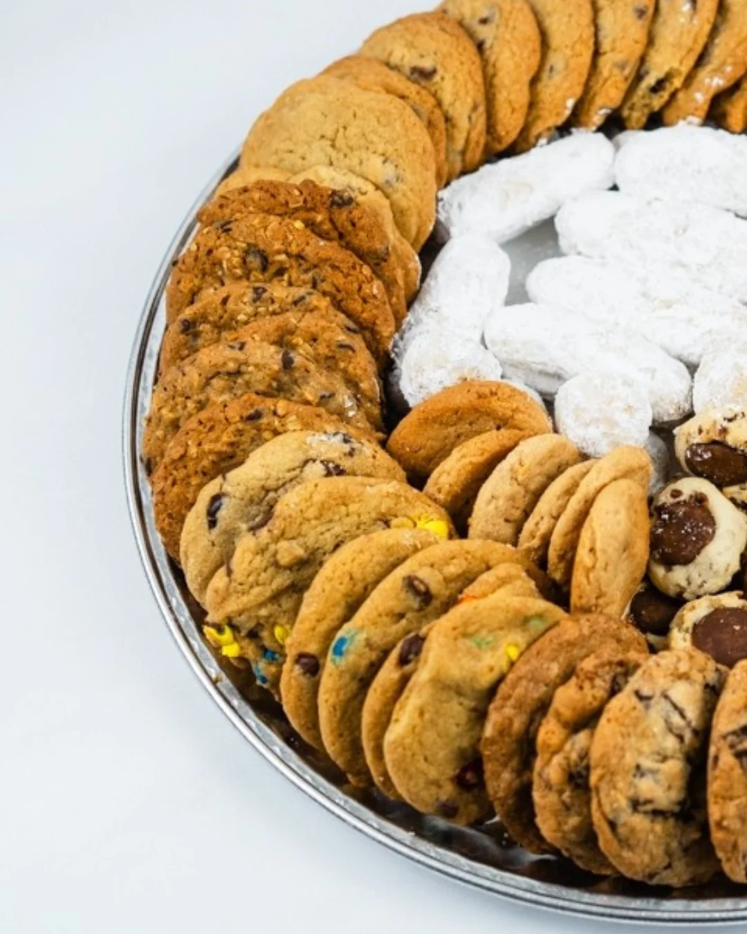 Assorted cookies on a silver platter for dessert