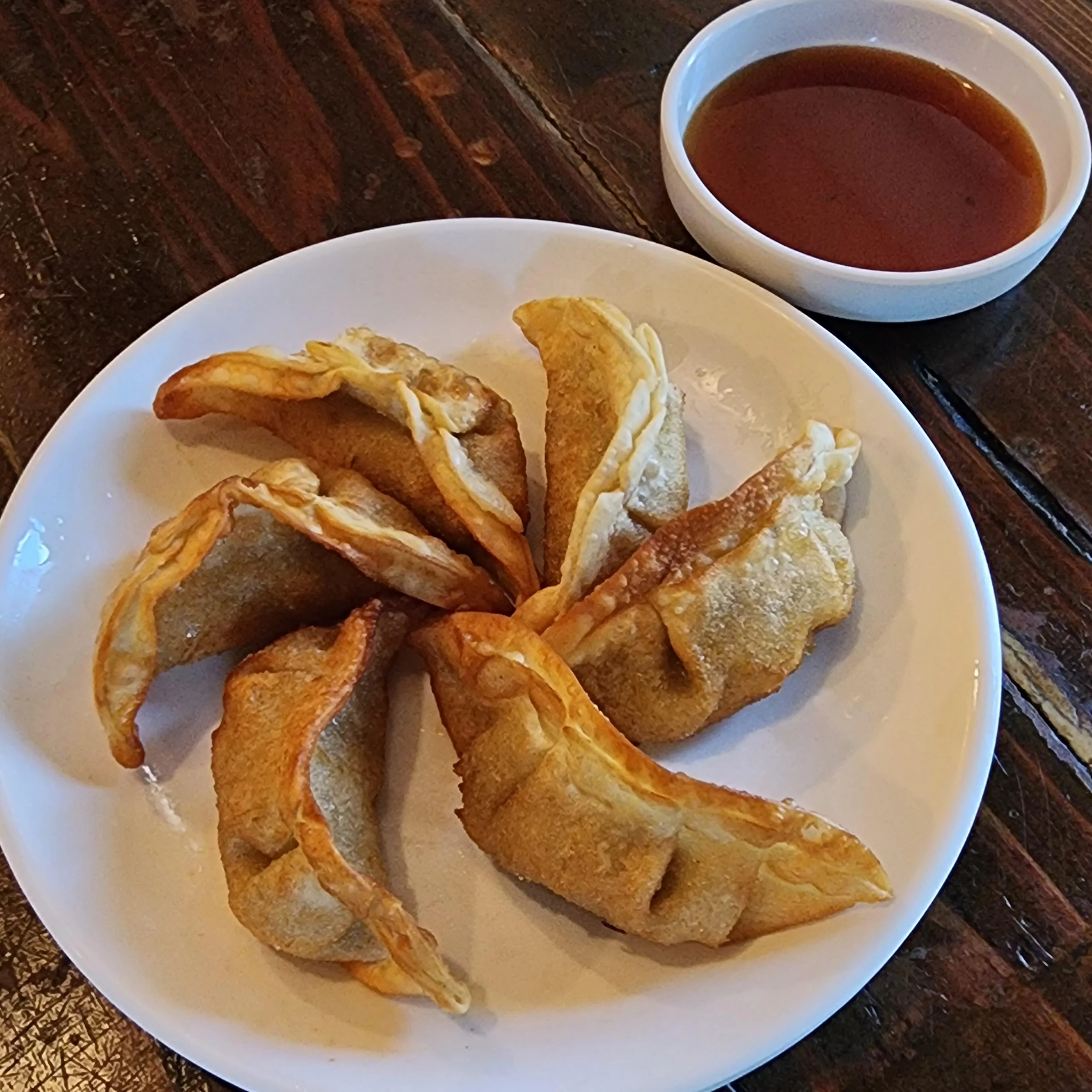 Crispy Chinese potstickers served with dipping sauce