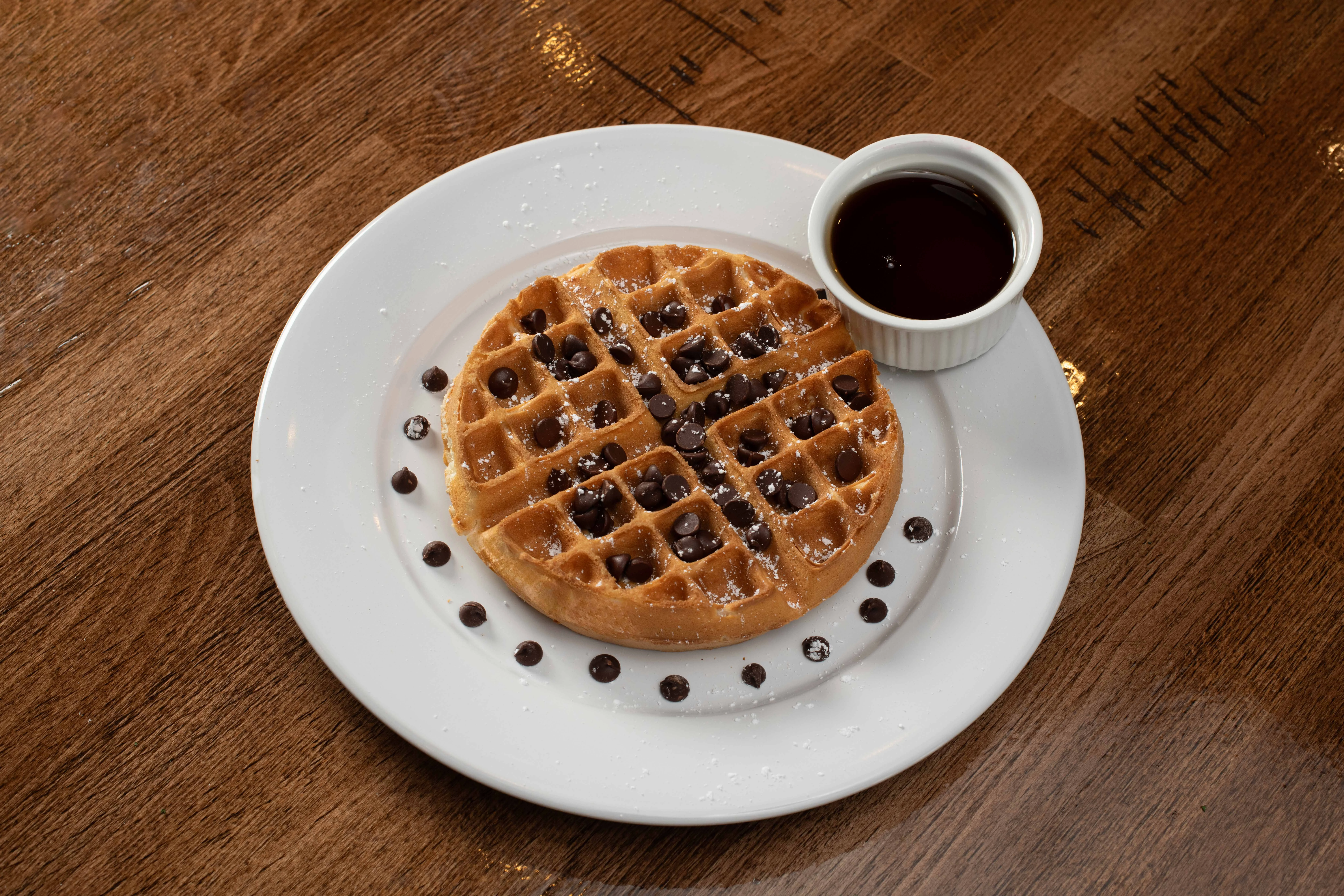 Delicious chocolate chip waffle with syrup