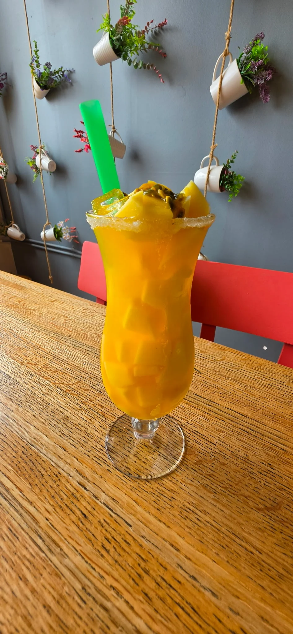 Colorful tropical cocktail with garnishes in a modern restaurant setting