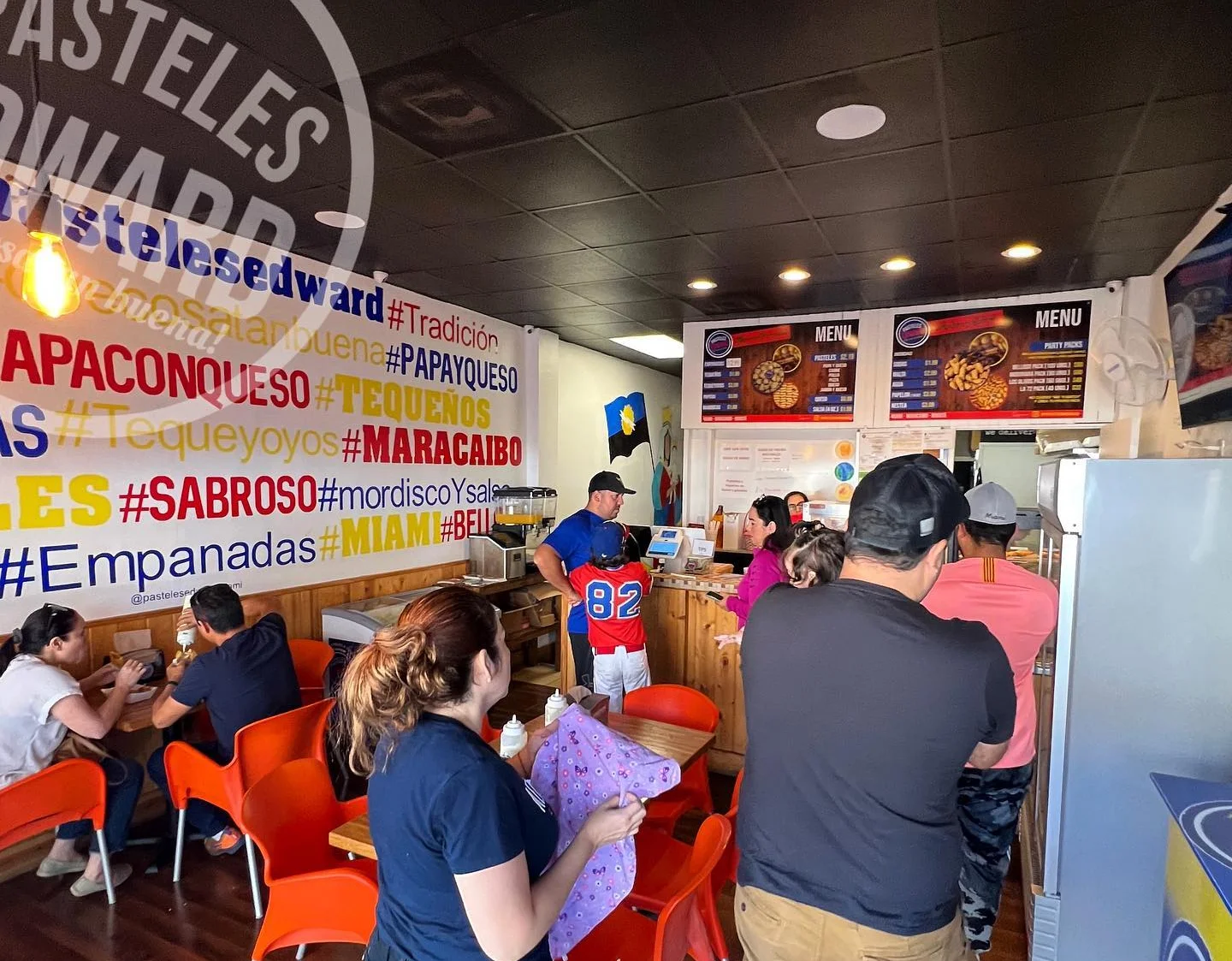 Vibrant restaurant interior with patrons enjoying Venezuelan pastries
