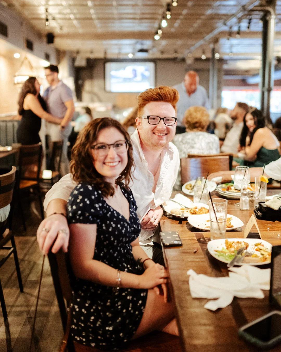 Couple enjoying a meal in a lively restaurant setting