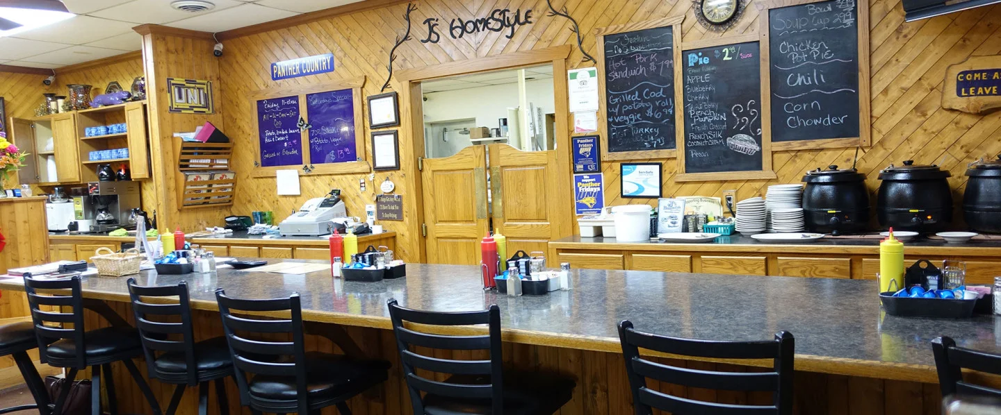 Cozy diner interior with wooden decor and menu boards