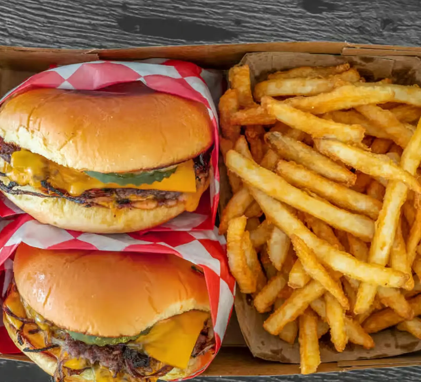 Delicious gourmet burger with fresh toppings on a wooden table