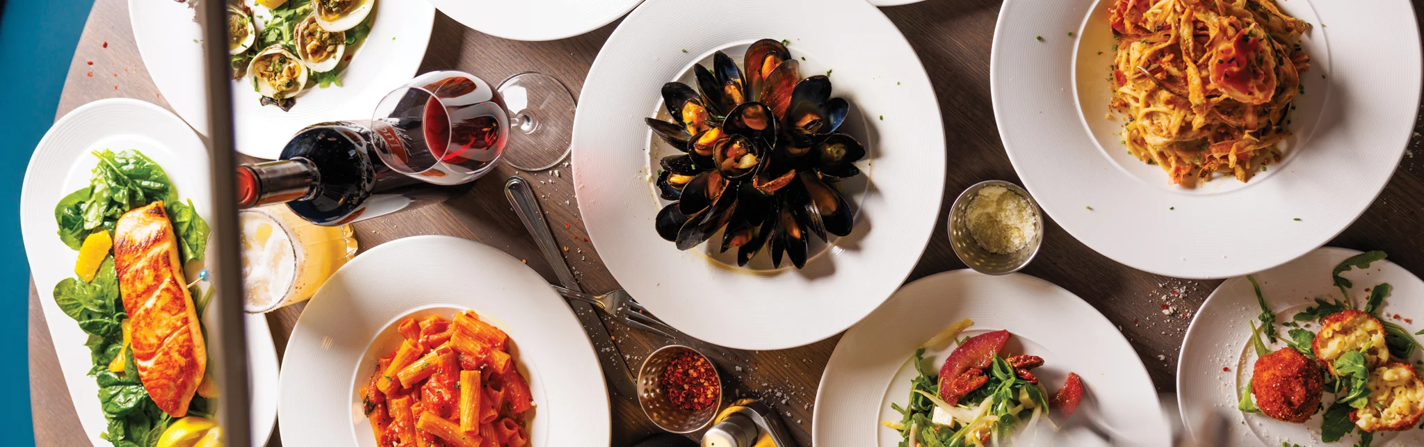Italian seafood platter with pasta and wine