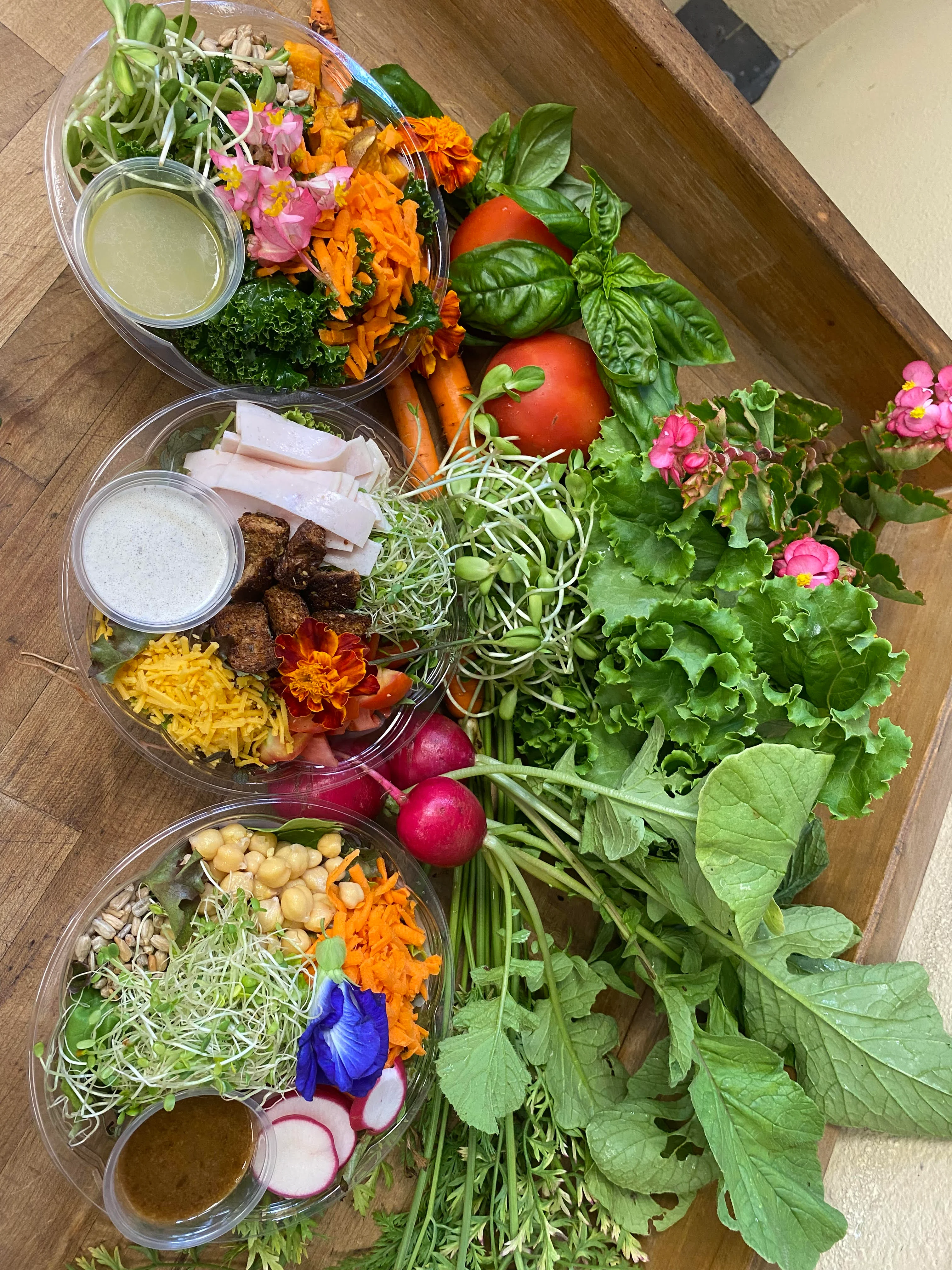 Colorful salad bowls with fresh vegetables and dressings