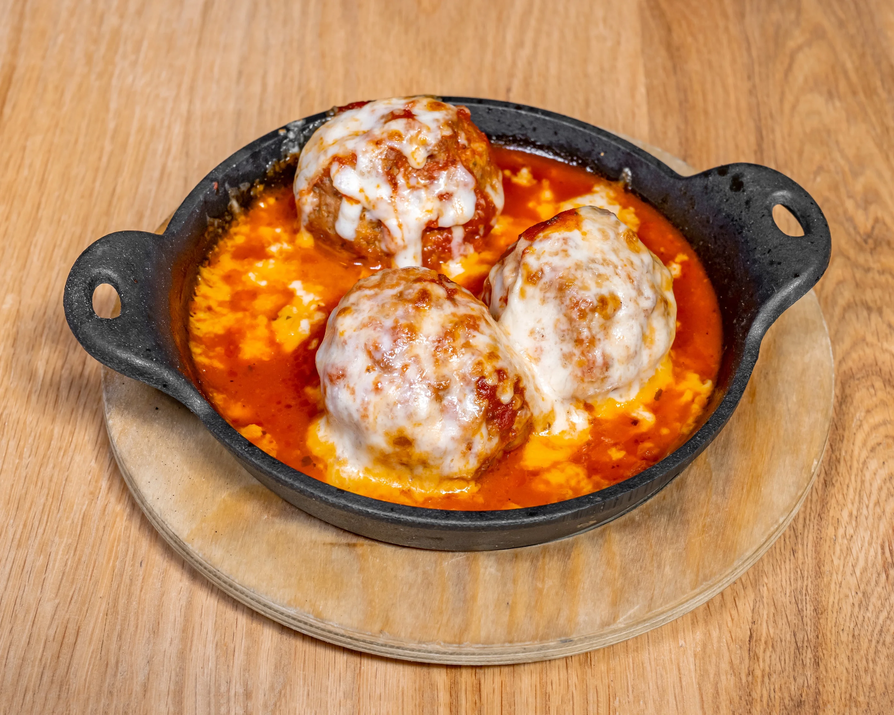 Italian meatballs in marinara sauce with melted cheese