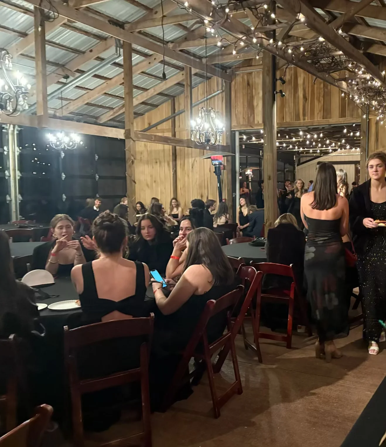 Elegant event space with guests enjoying pizza and festive decor