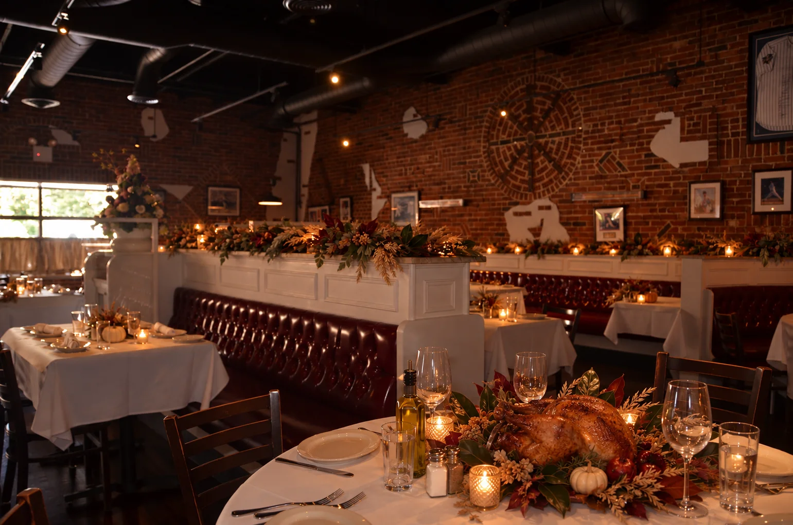 Elegant restaurant dining room with a roasted turkey centerpiece and autumn decor
