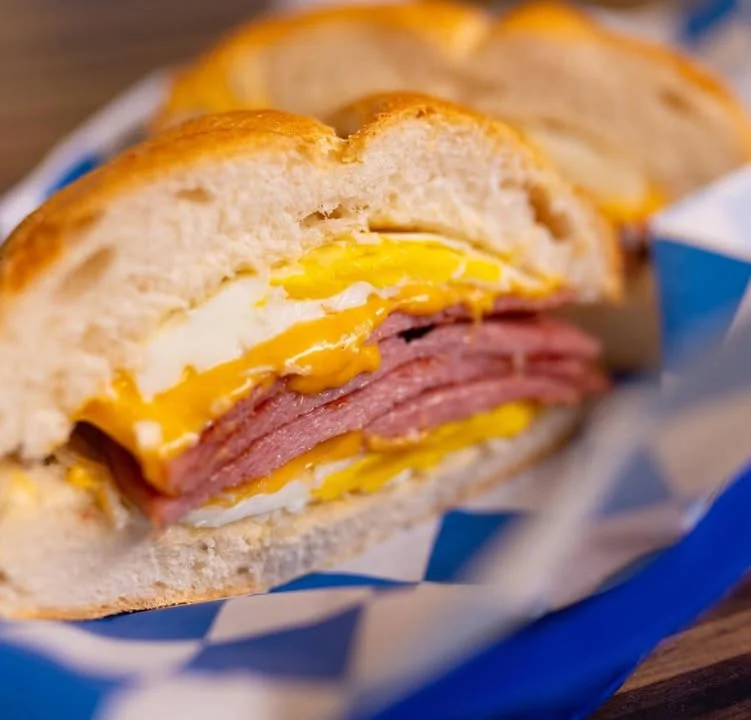 Breakfast sandwich with eggs and ham on a soft bun