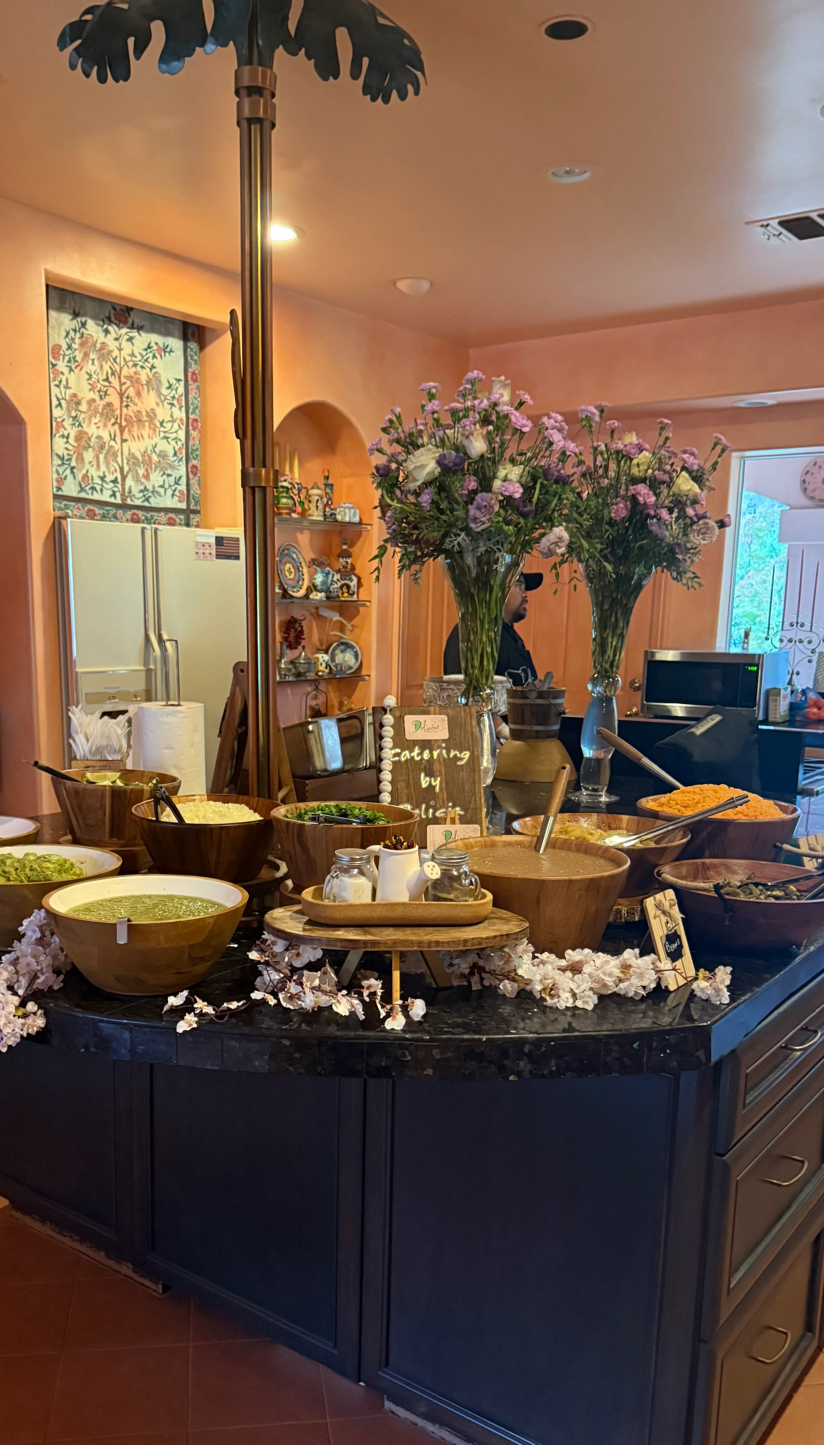 Catering buffet with assorted dishes and floral decor