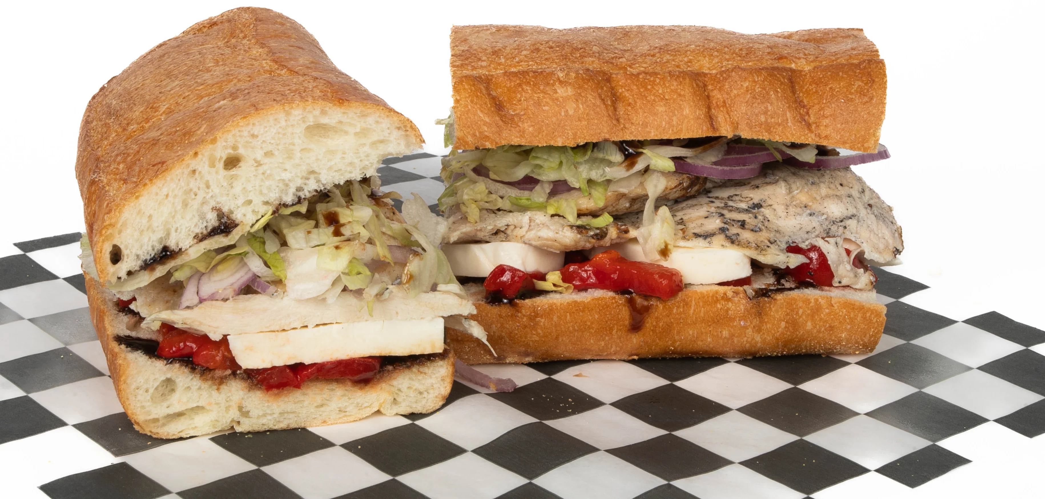 A sandwich filled with shredded beef on a toasted roll, cut in half to show the tender filling inside.