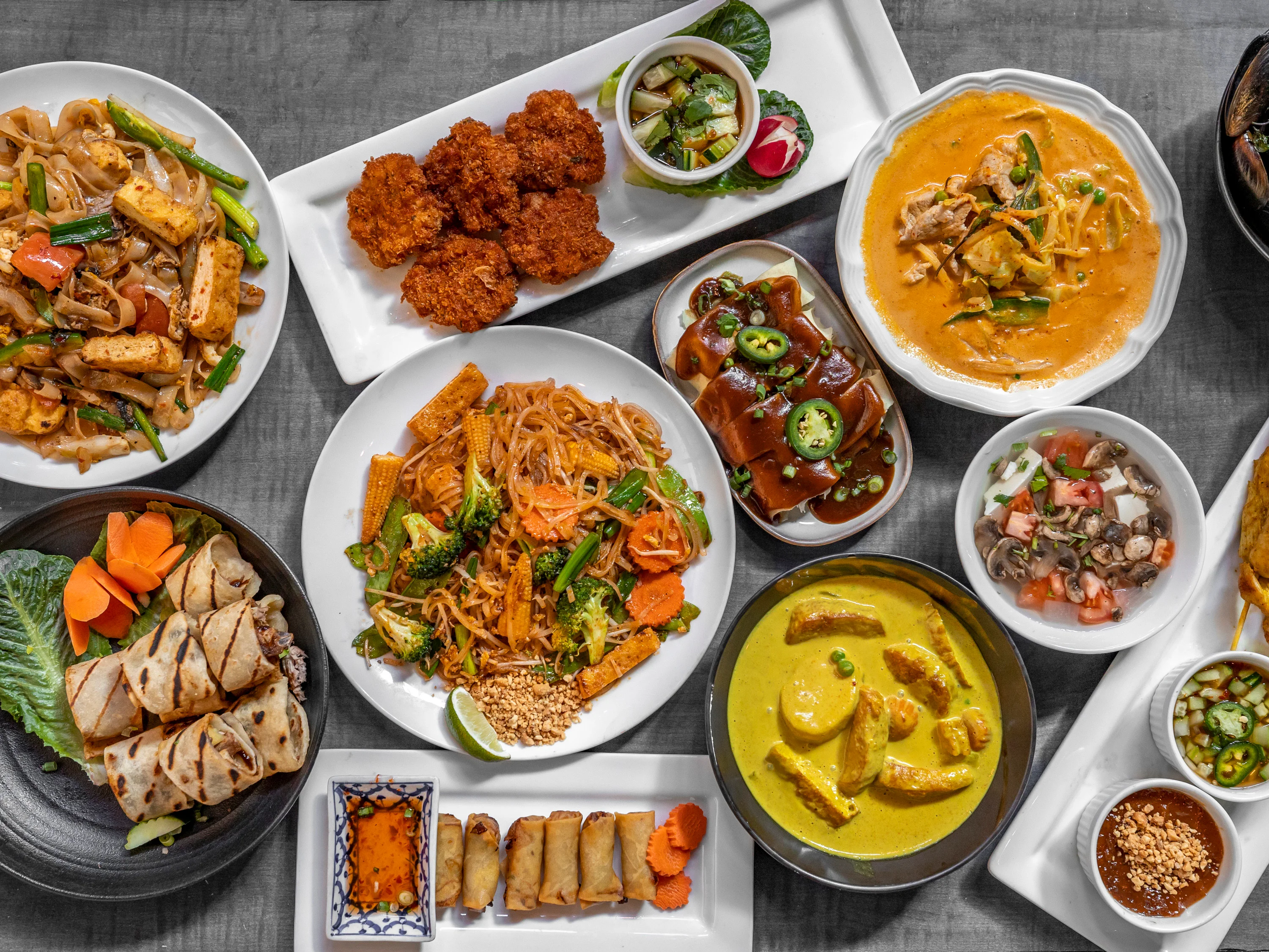 Assorted Thai dishes including pad thai and curry