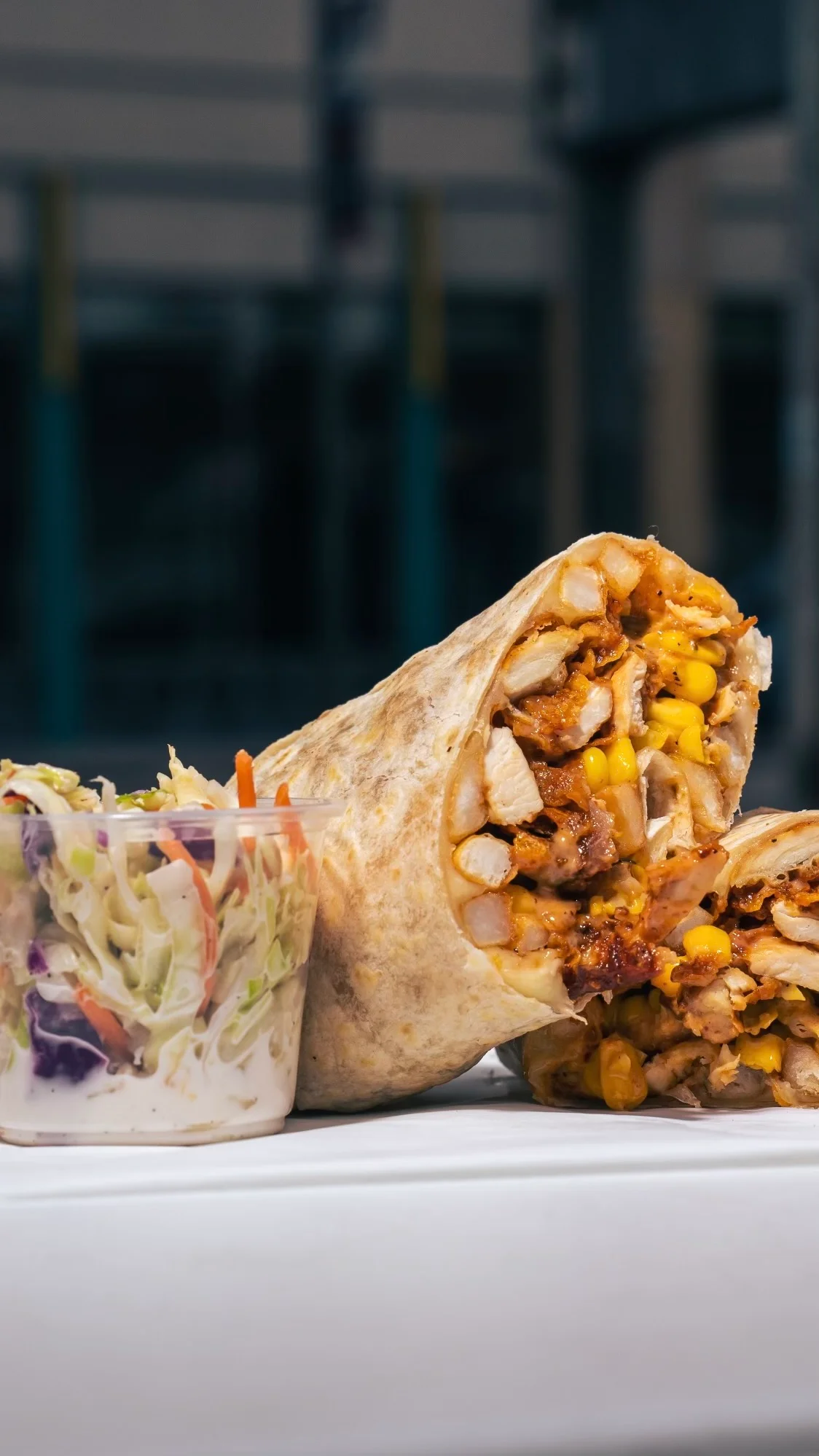 Delicious wrap filled with fresh ingredients on a wooden table.