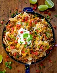 Loaded nachos topped with cheese and sour cream
