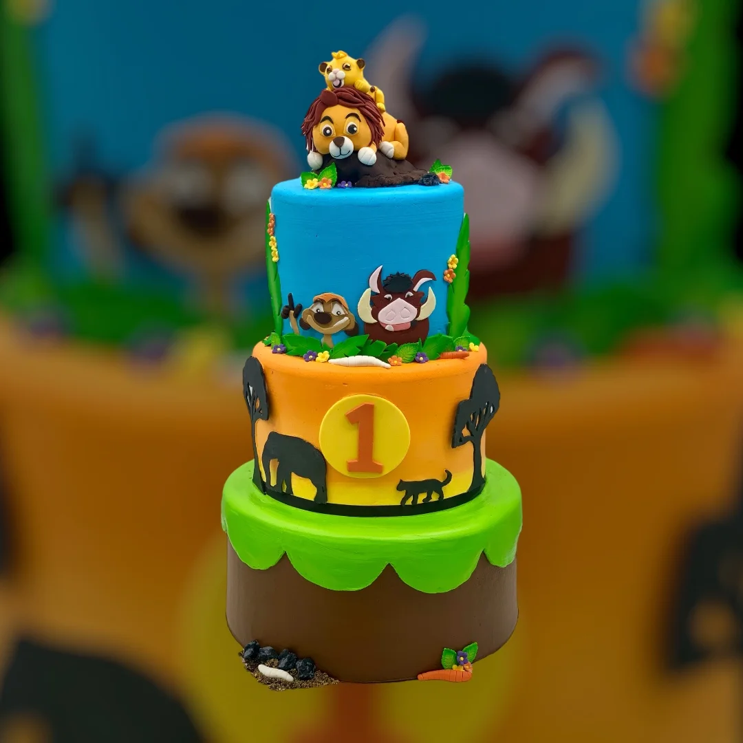 Colorful birthday cake featuring jungle animals and characters