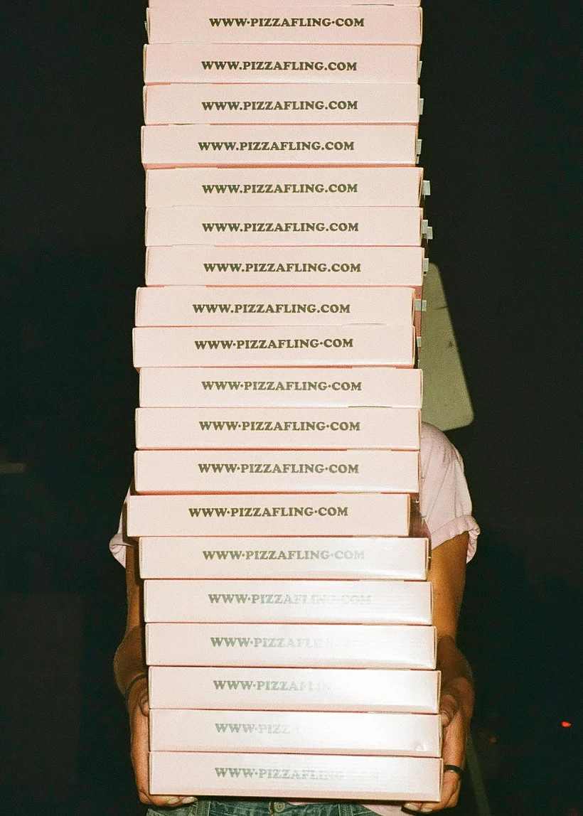 Stack of pizza boxes from a popular pizzeria