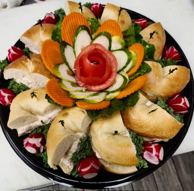 Assorted bagel platter with decorative vegetable arrangement