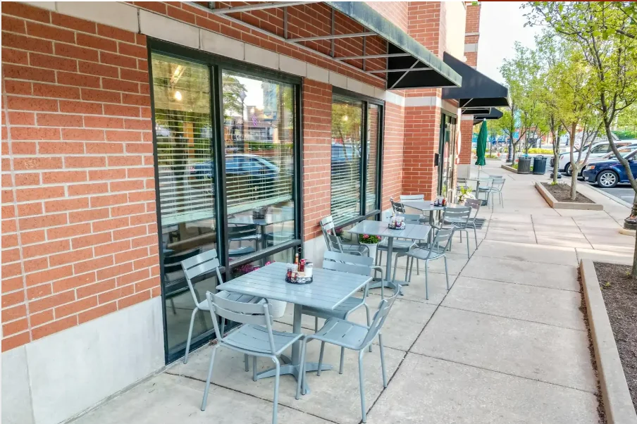 Outdoor dining area with modern tables and chairs