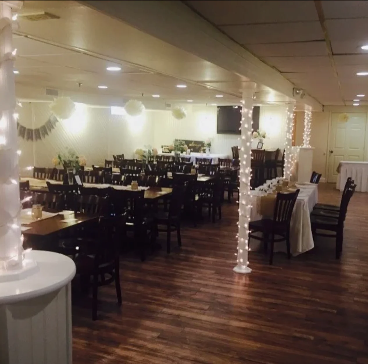 Cozy restaurant interior with warm lighting and wooden tables