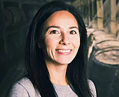 Professional woman smiling in a modern restaurant setting