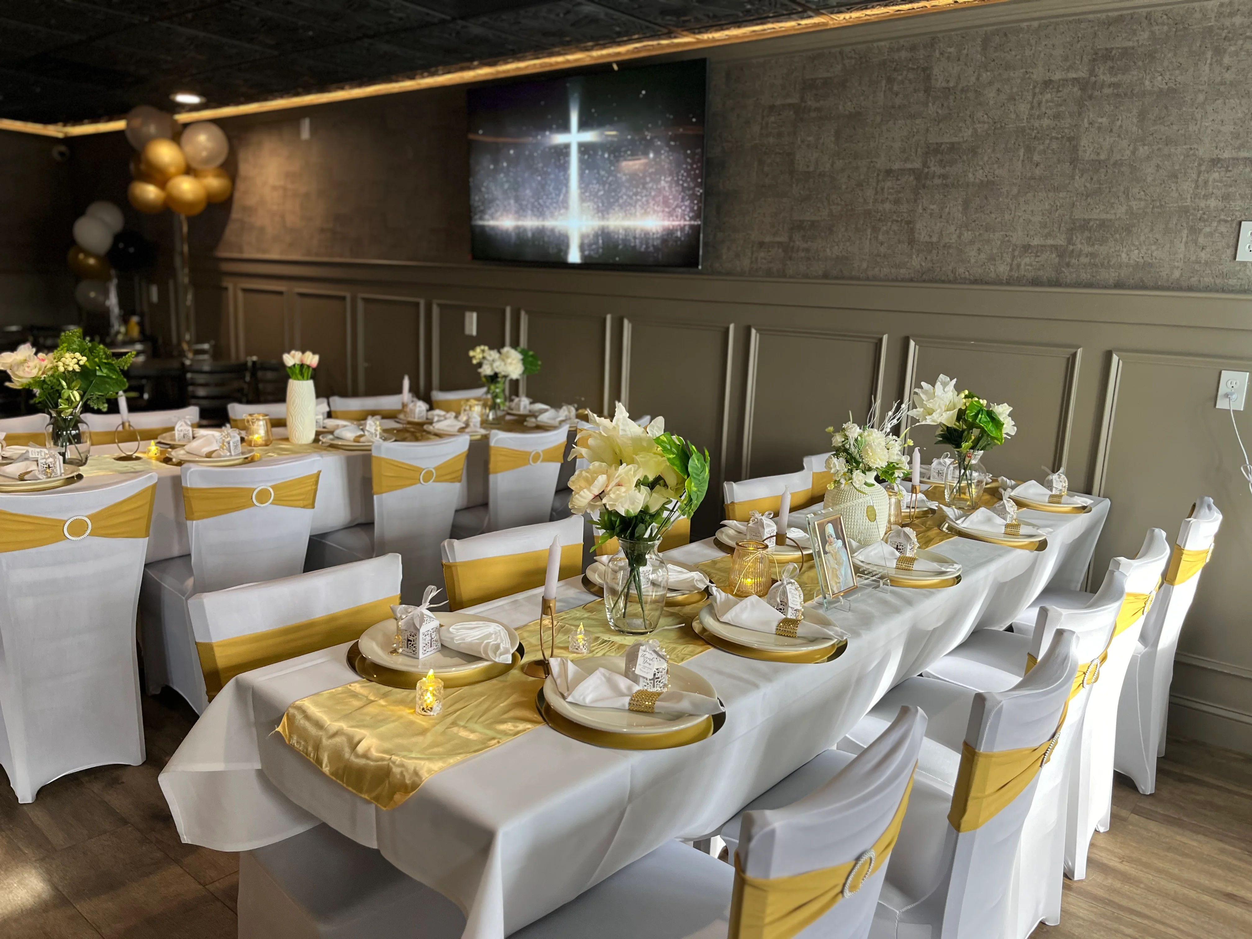 Elegant restaurant dining setup with gold accents and floral arrangements
