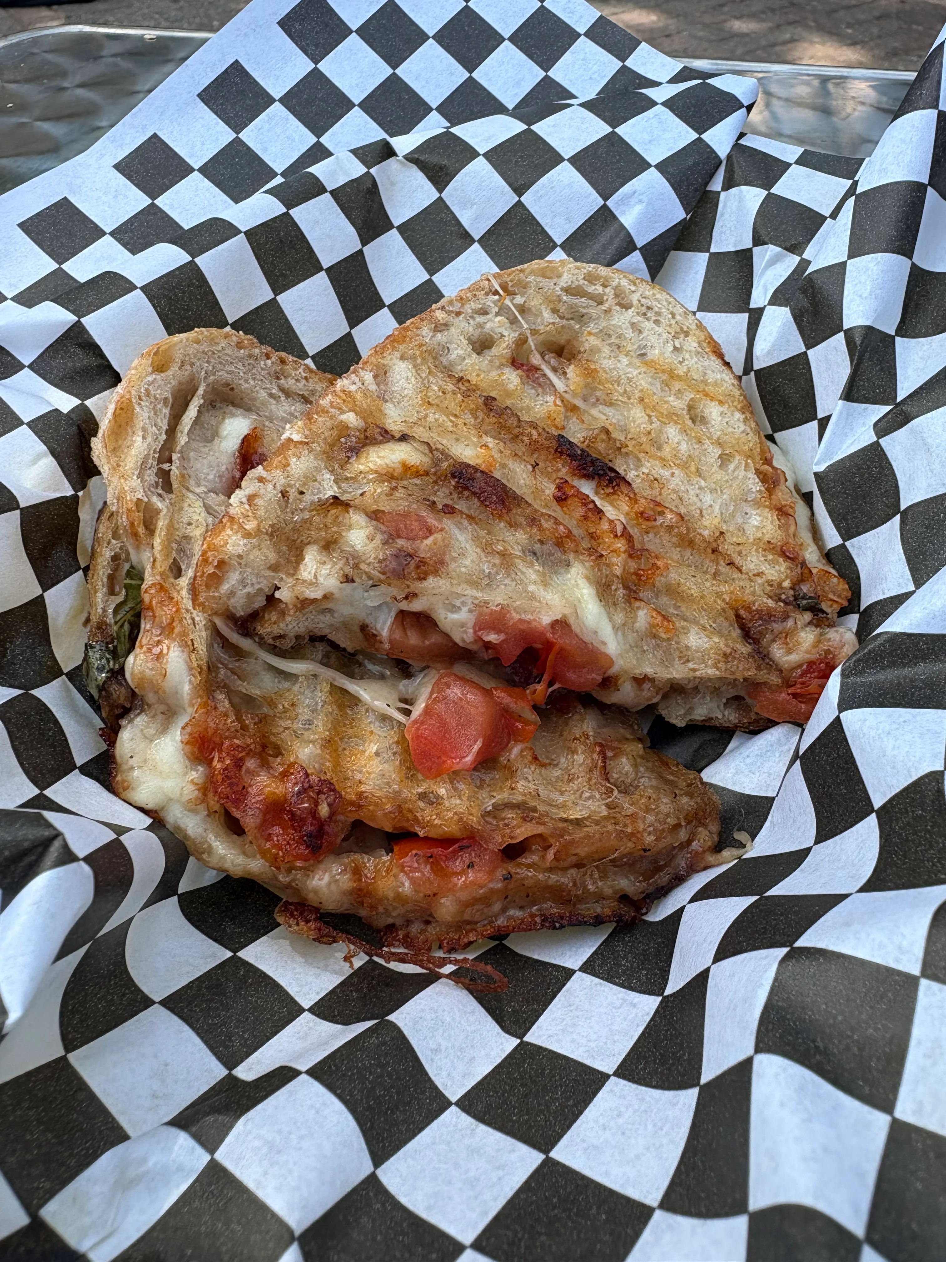 Grilled cheese sandwich with tomatoes on artisan bread