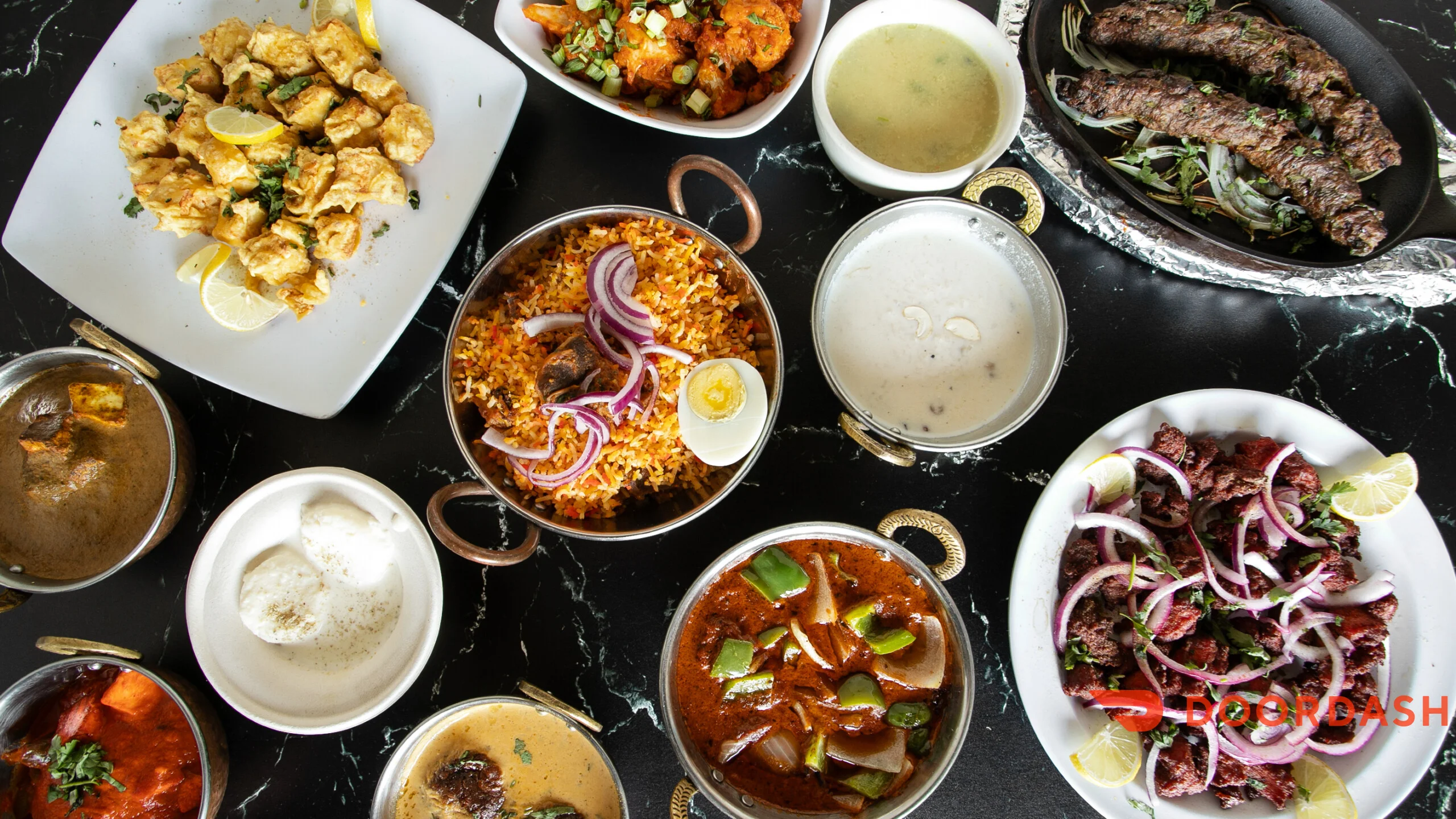 Assorted Indian dishes including biryani and kebabs