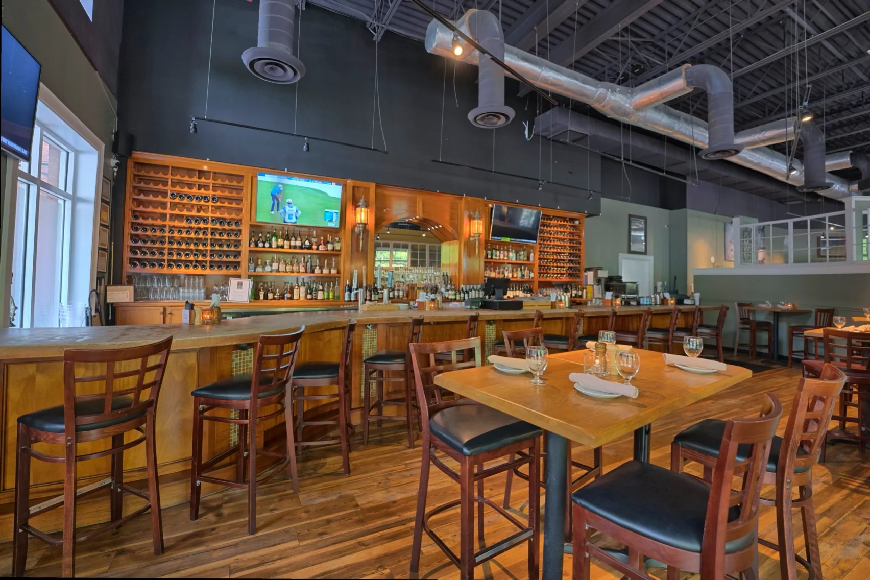 Modern restaurant interior with bar and wooden tables