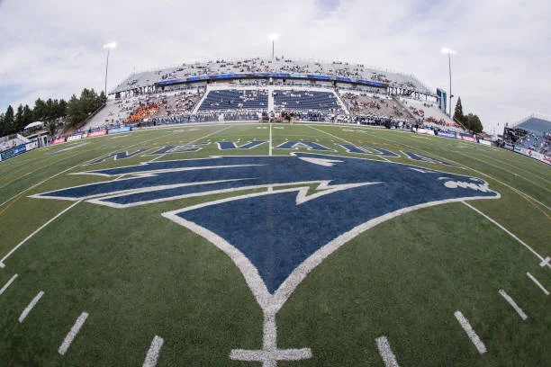 Nevada football field with team logo and empty stands