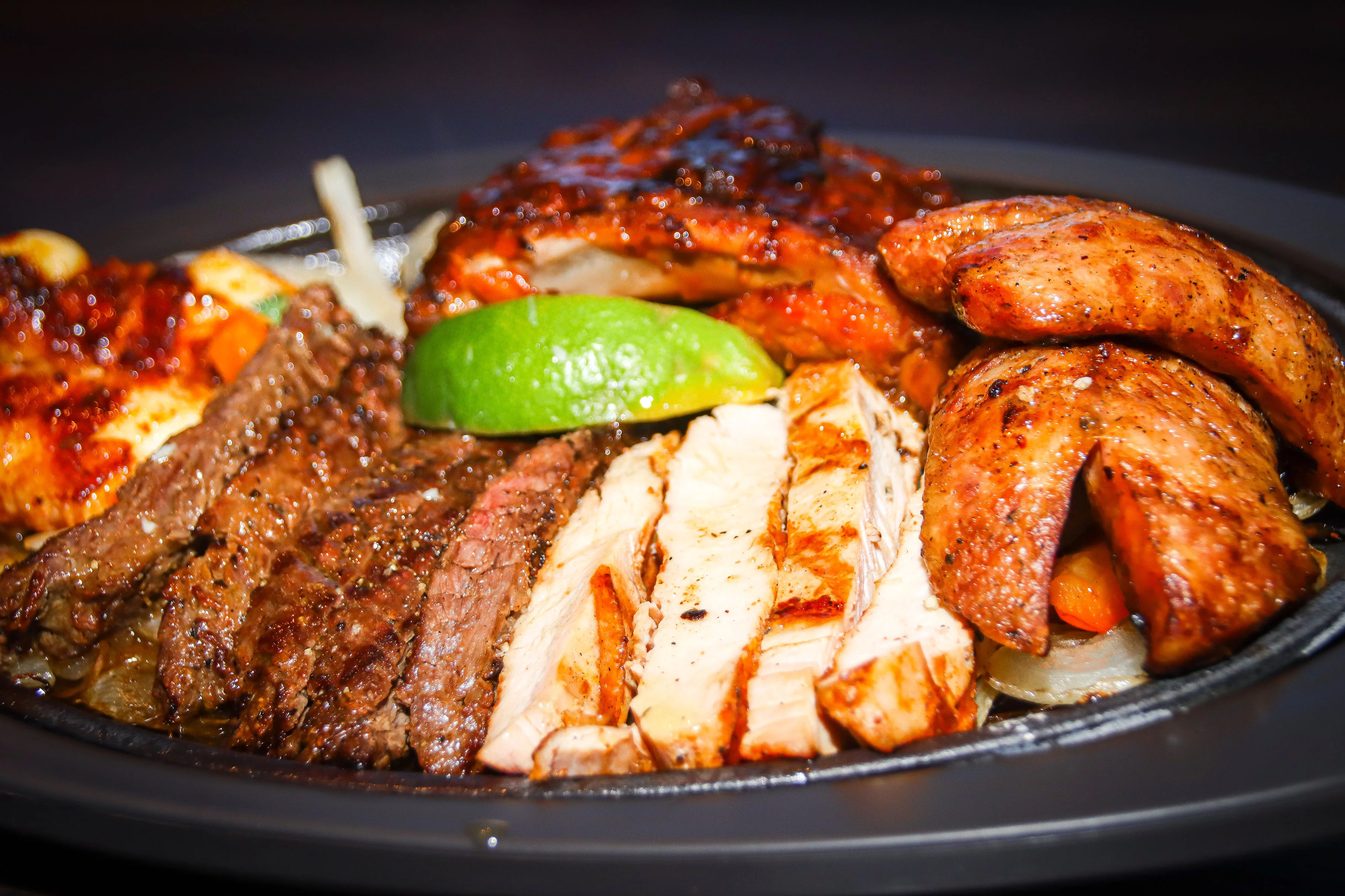 Sizzling fajitas platter with grilled meats