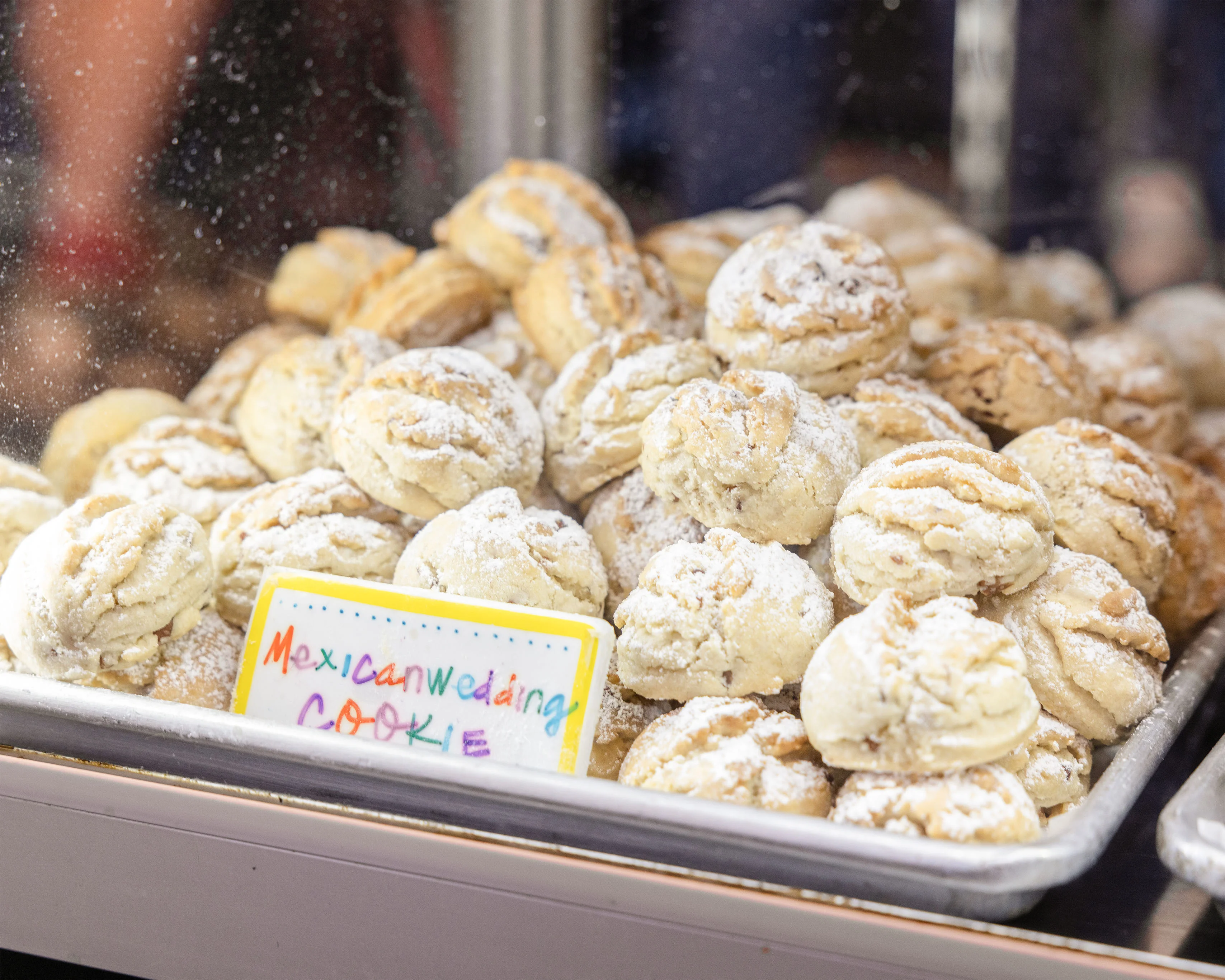 Mexican wedding cookies in a bakery display case