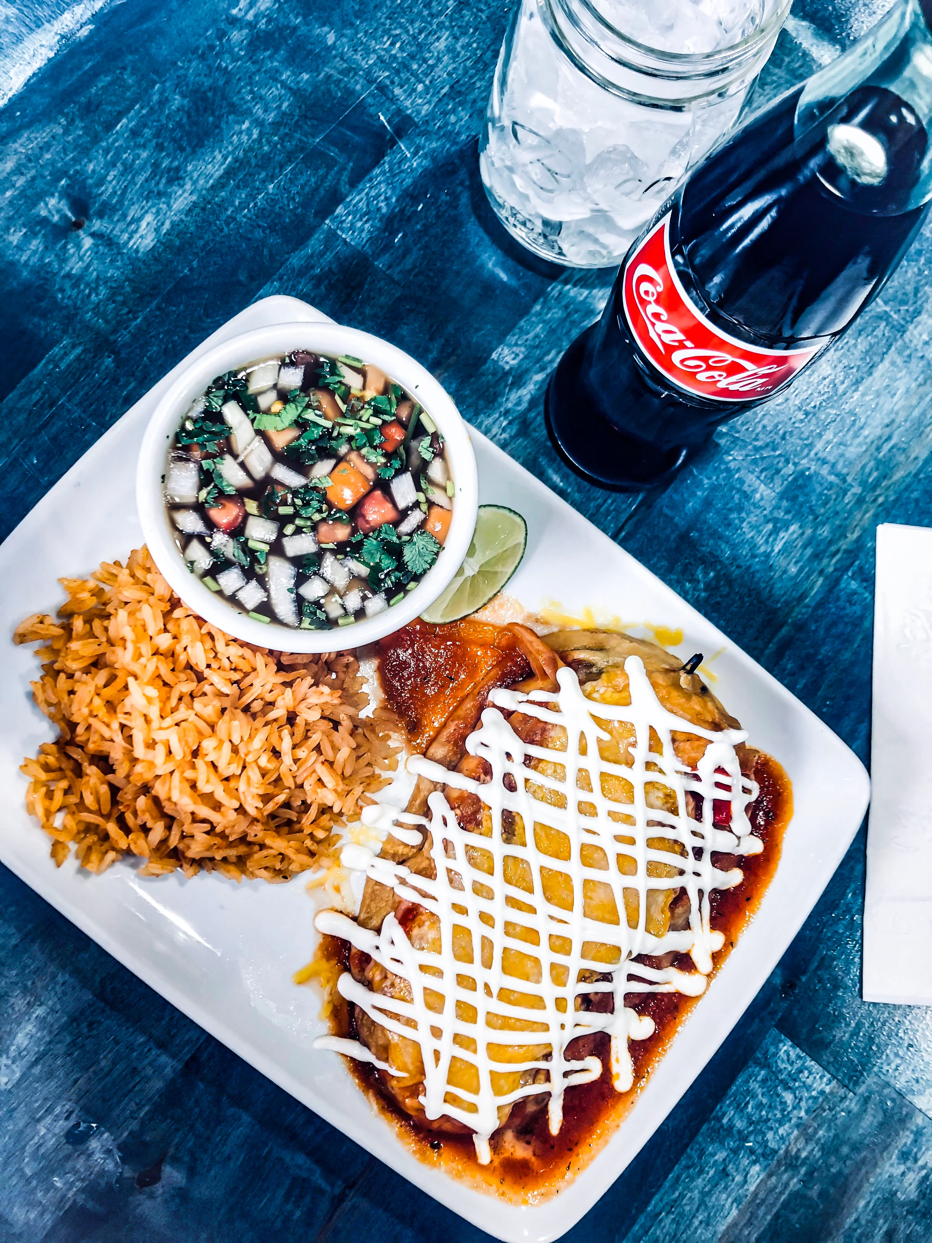 Plate of enchiladas with rice and salsa in a Mexican restaurant