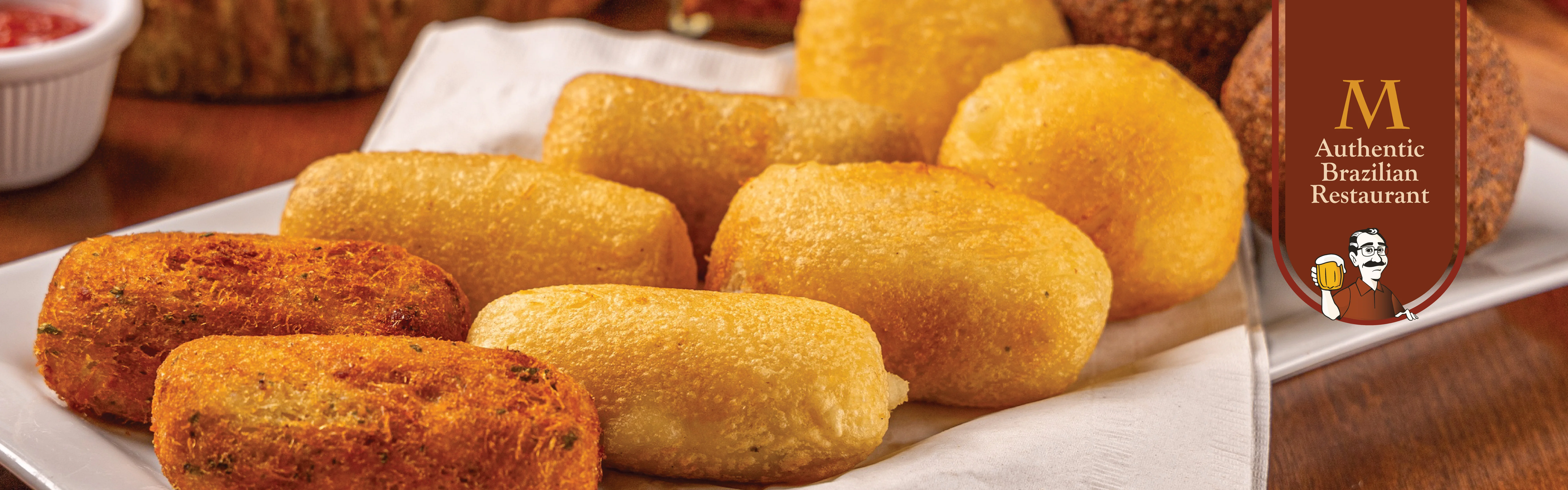 Plate of Brazilian coxinhas and bolinhos de bacalhau