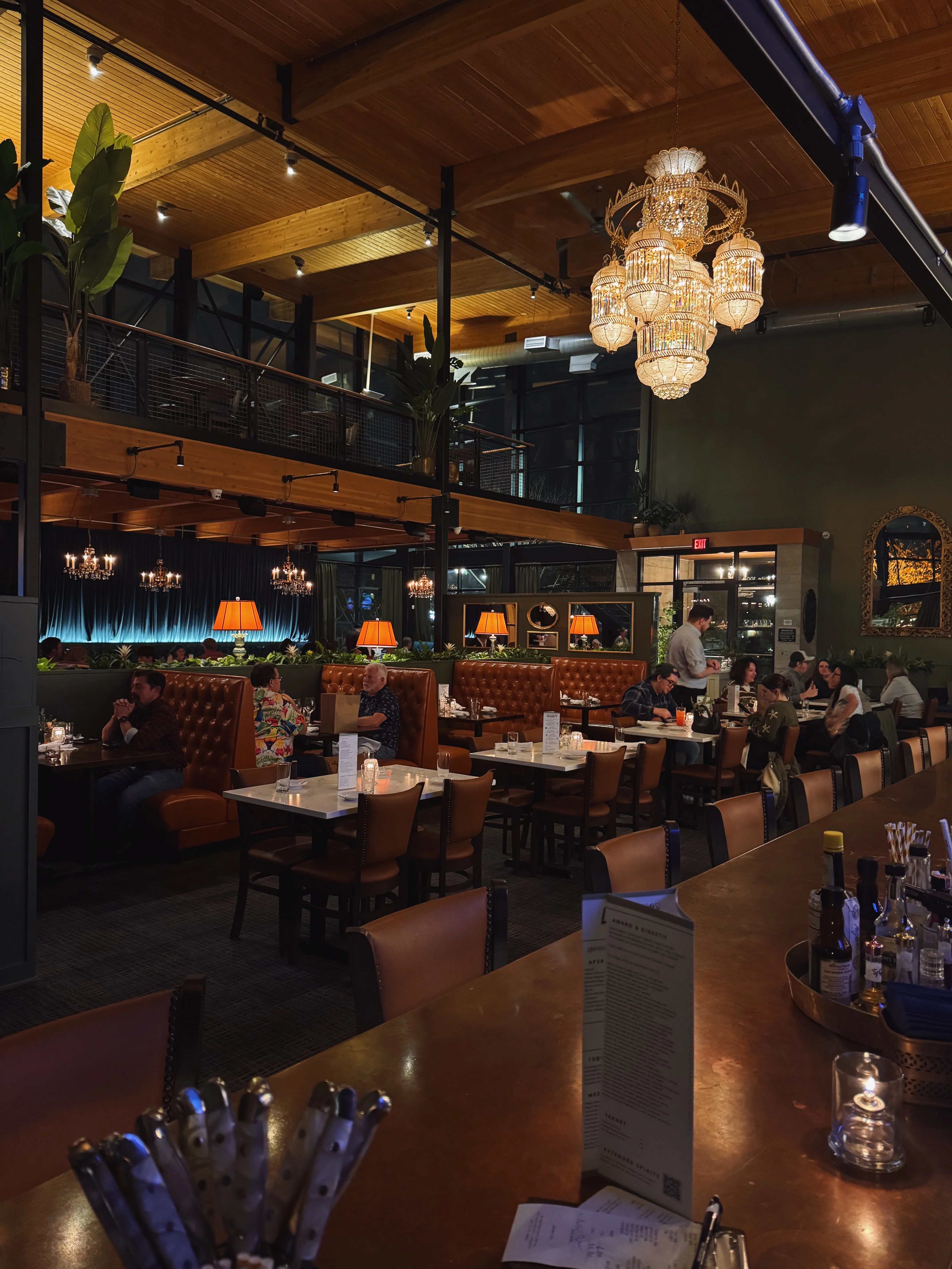 Cozy restaurant interior with elegant chandeliers and warm lighting