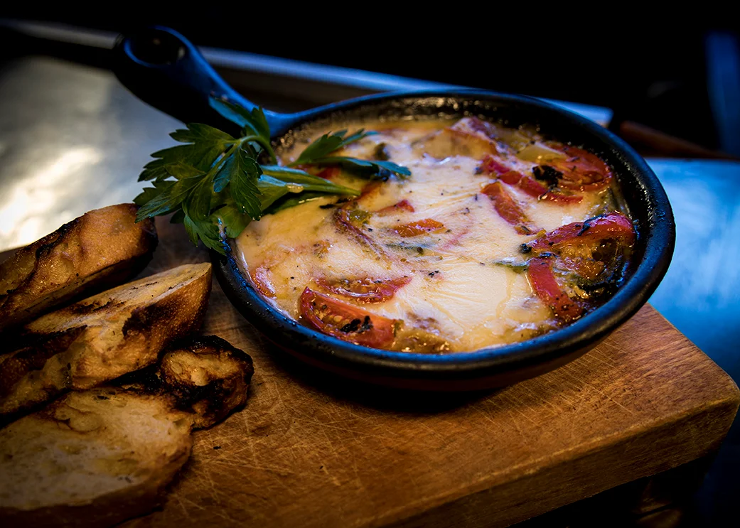 Baked Mediterranean shakshuka with tomatoes and herbs