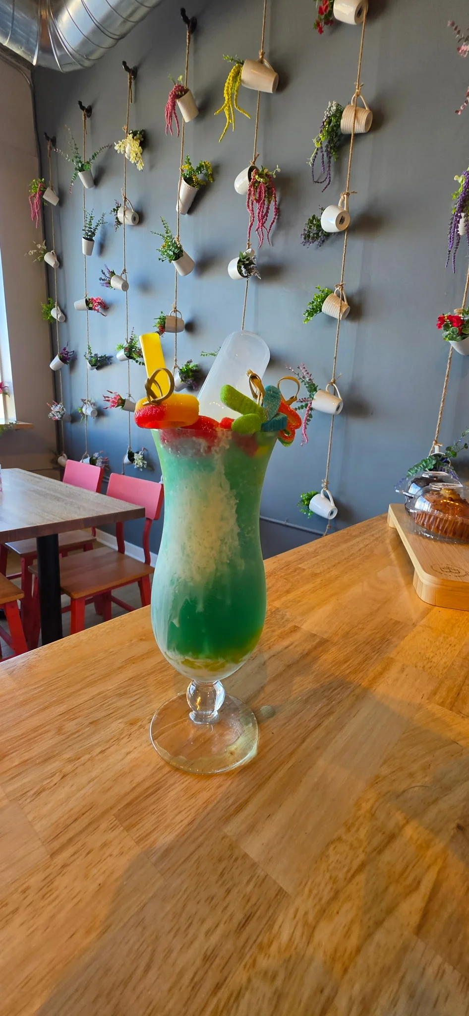 Colorful tropical cocktail with garnishes in a modern cafe setting