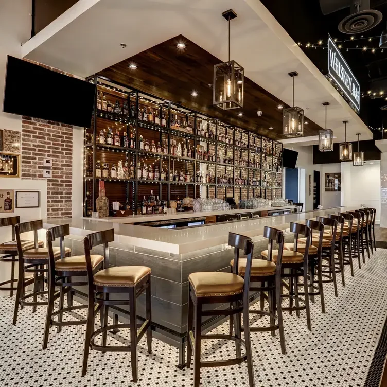 Stylish whiskey bar interior with warm lighting