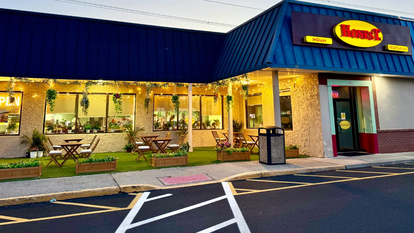 Charming Indian vegetarian restaurant exterior with outdoor seating