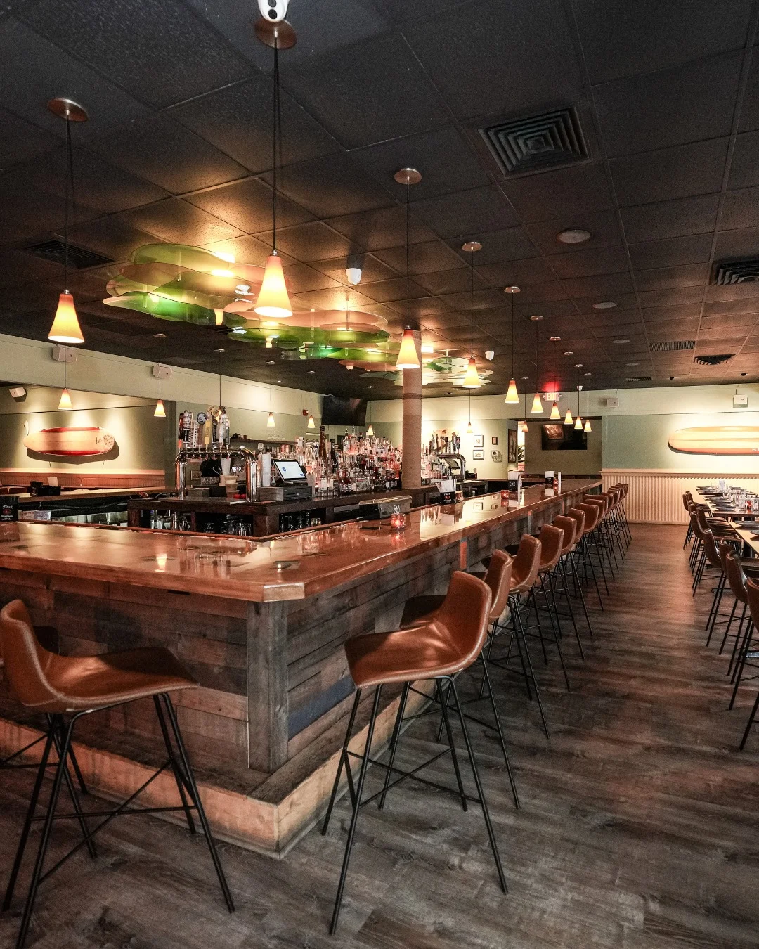 Stylish restaurant bar and dining room with warm pendant lighting