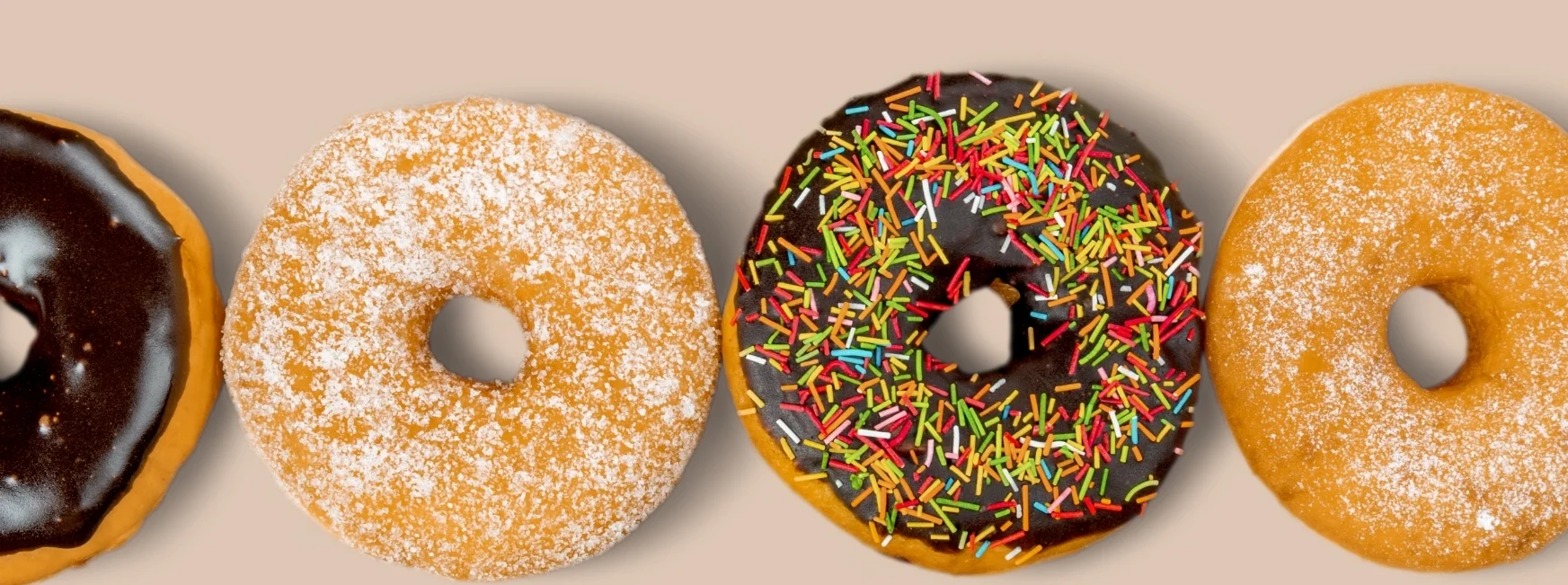 display of chocolate donut, sprinkled donuts, and sugar donuts