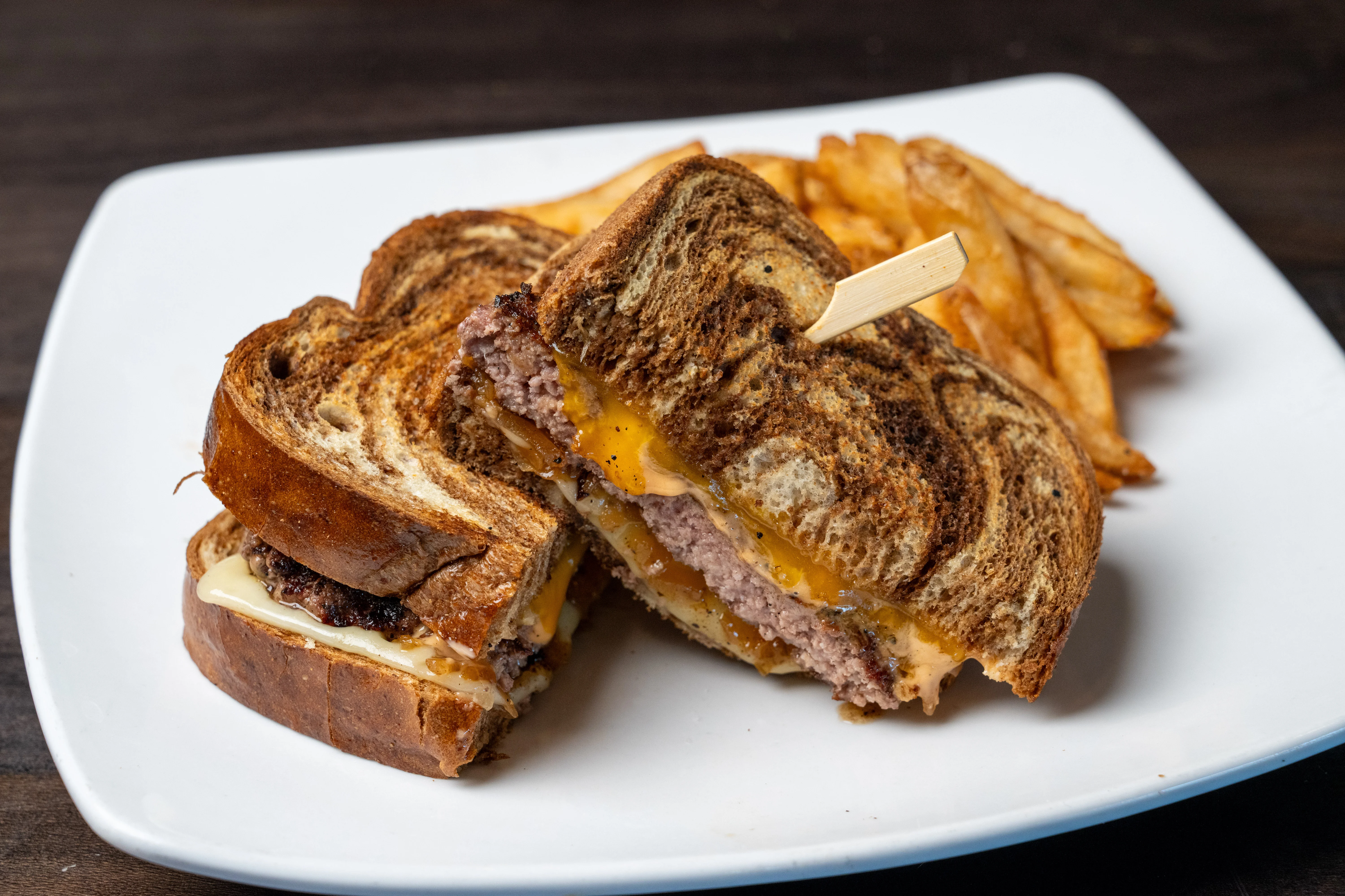 Grilled cheese burger sandwich with fries