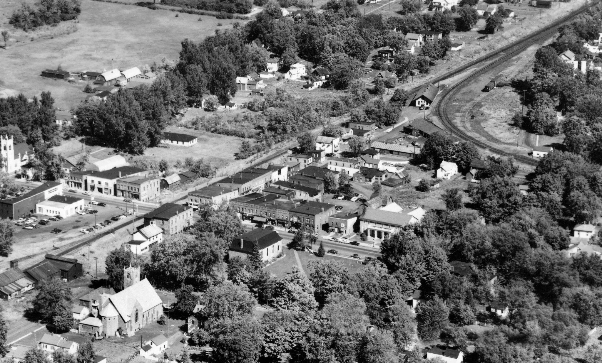 Aerial view of a small town with houses and a railway