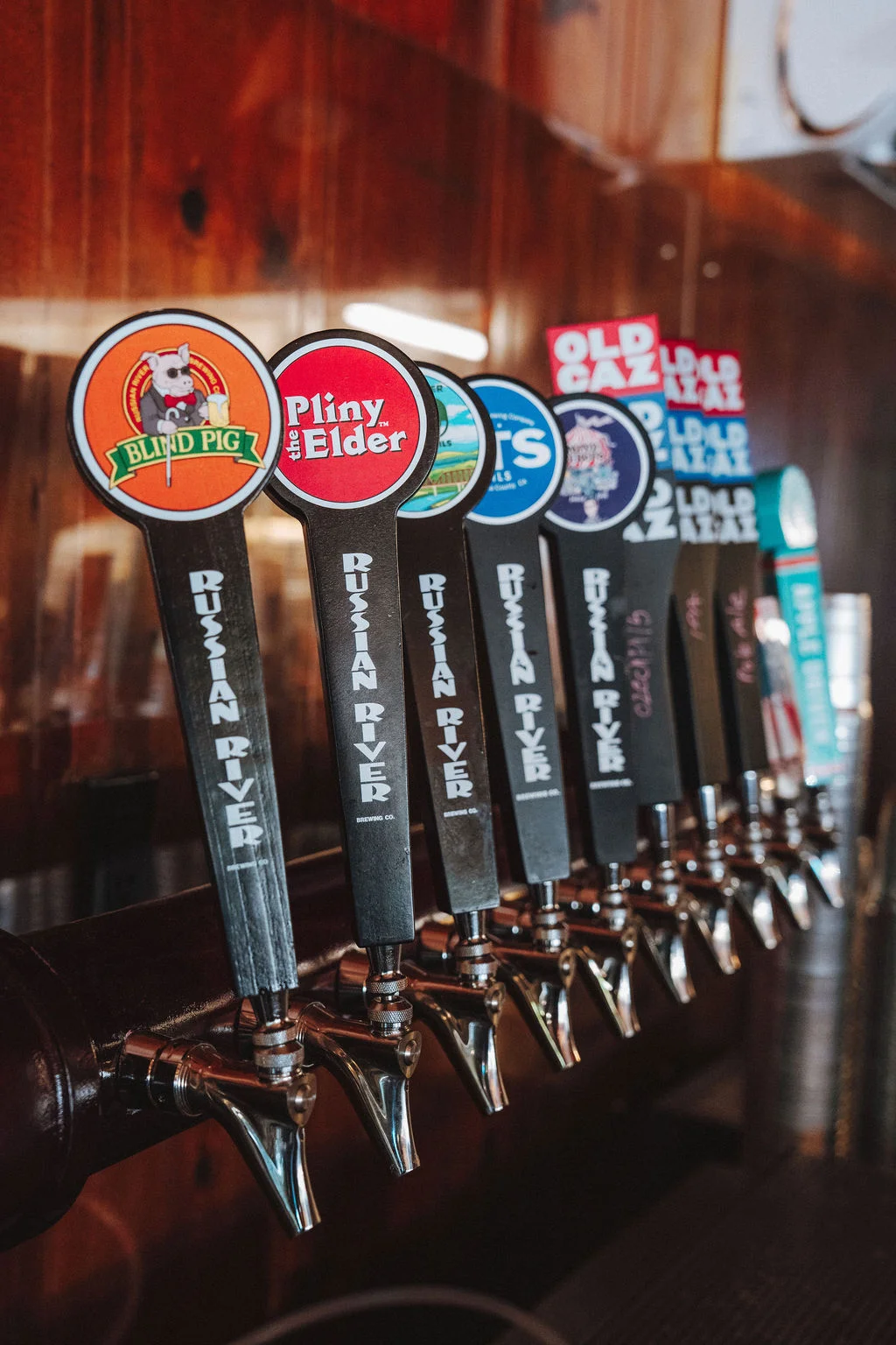 Craft beer taps featuring various brews at a bar