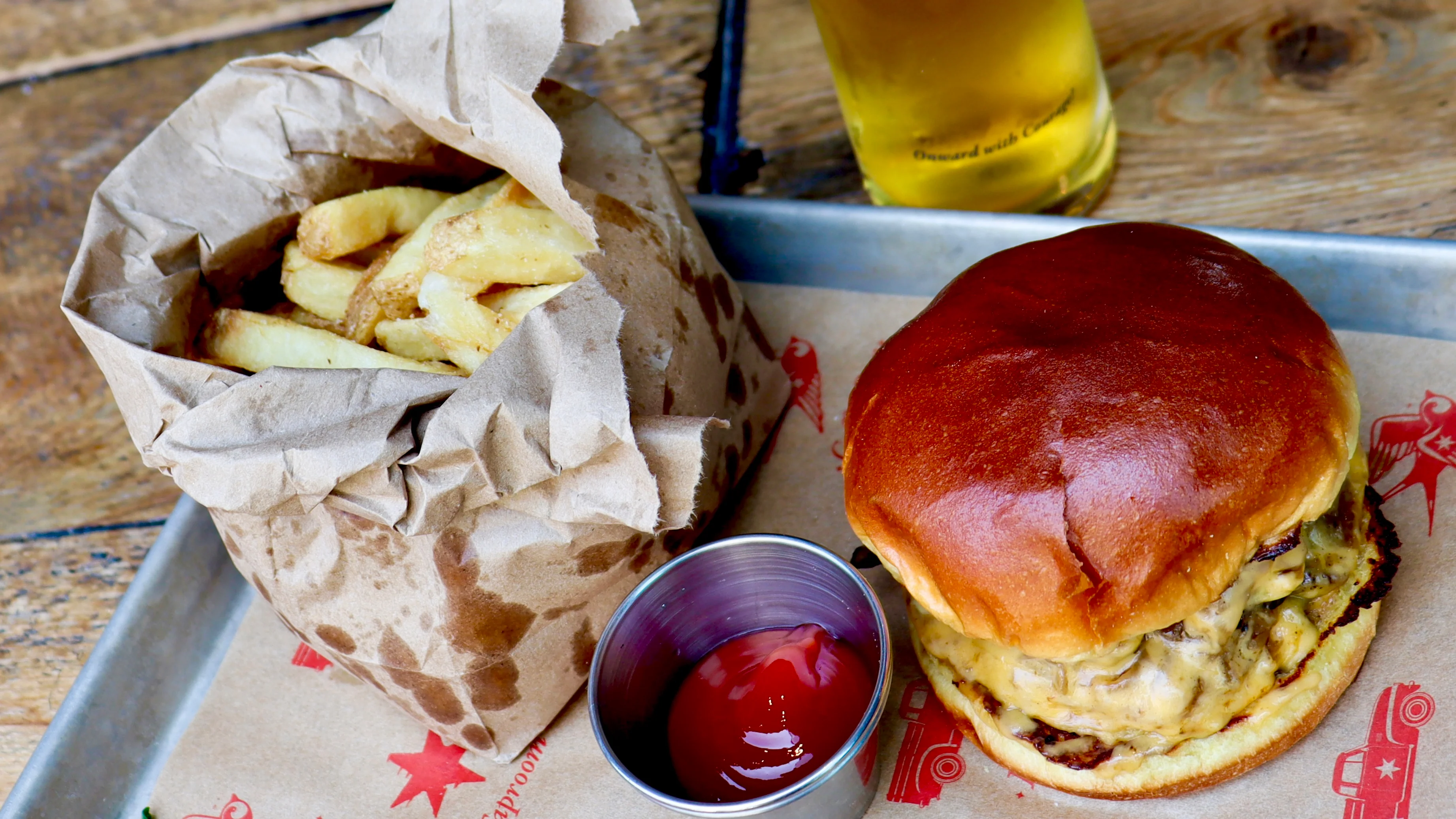 Juicy cheeseburger with fries and ketchup