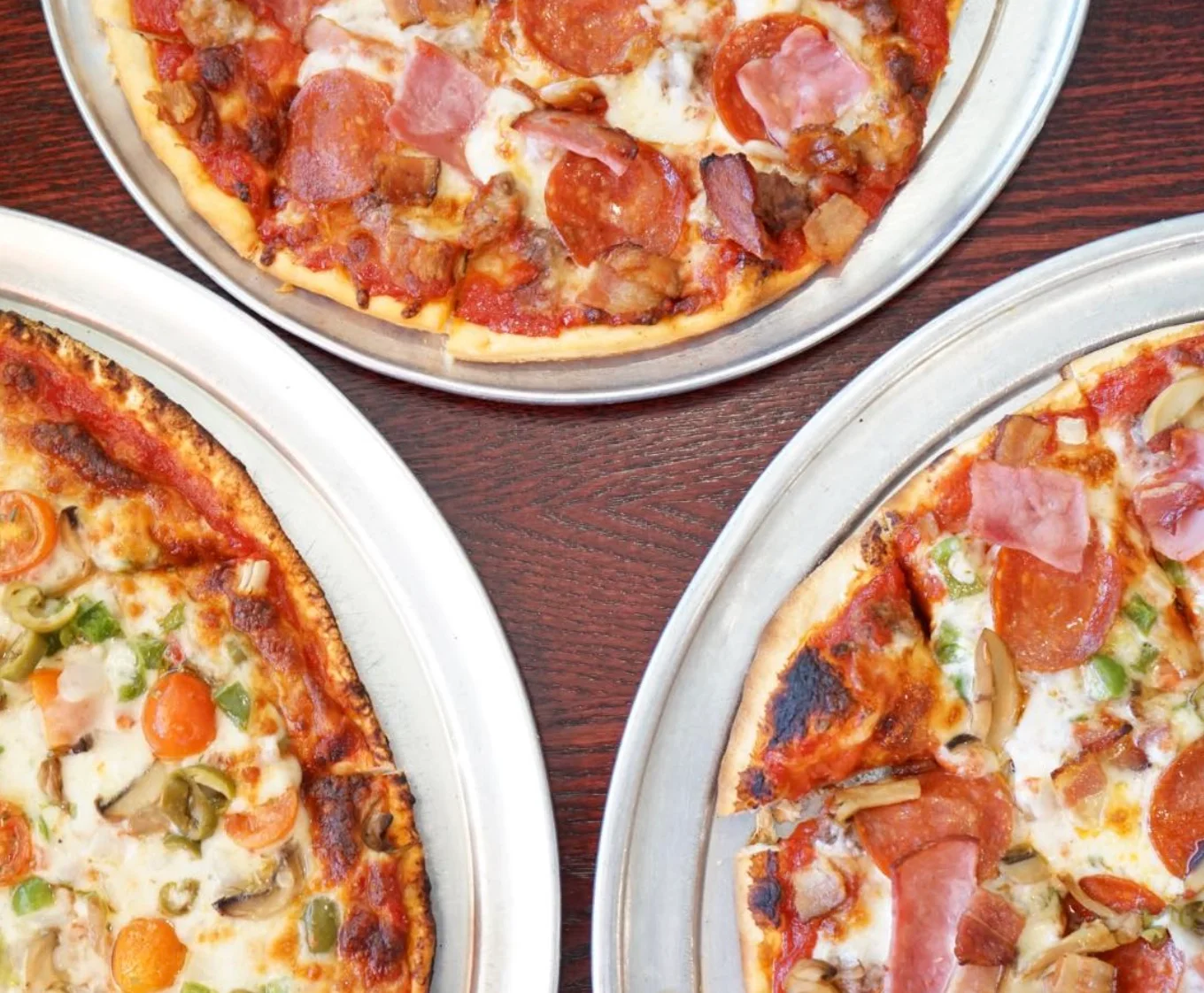 Assorted pizzas including pepperoni and veggie styles