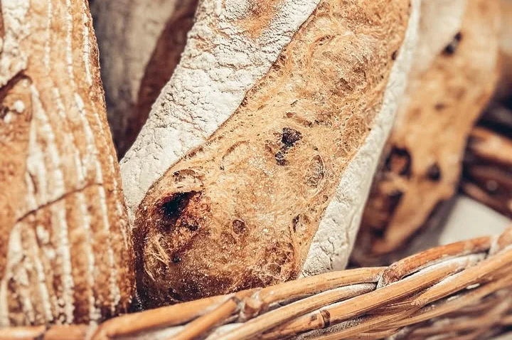 Artisan sourdough bread loaves in a wicker basket