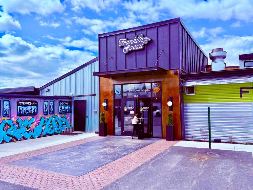Entrance of Franklin Social restaurant with vibrant street art