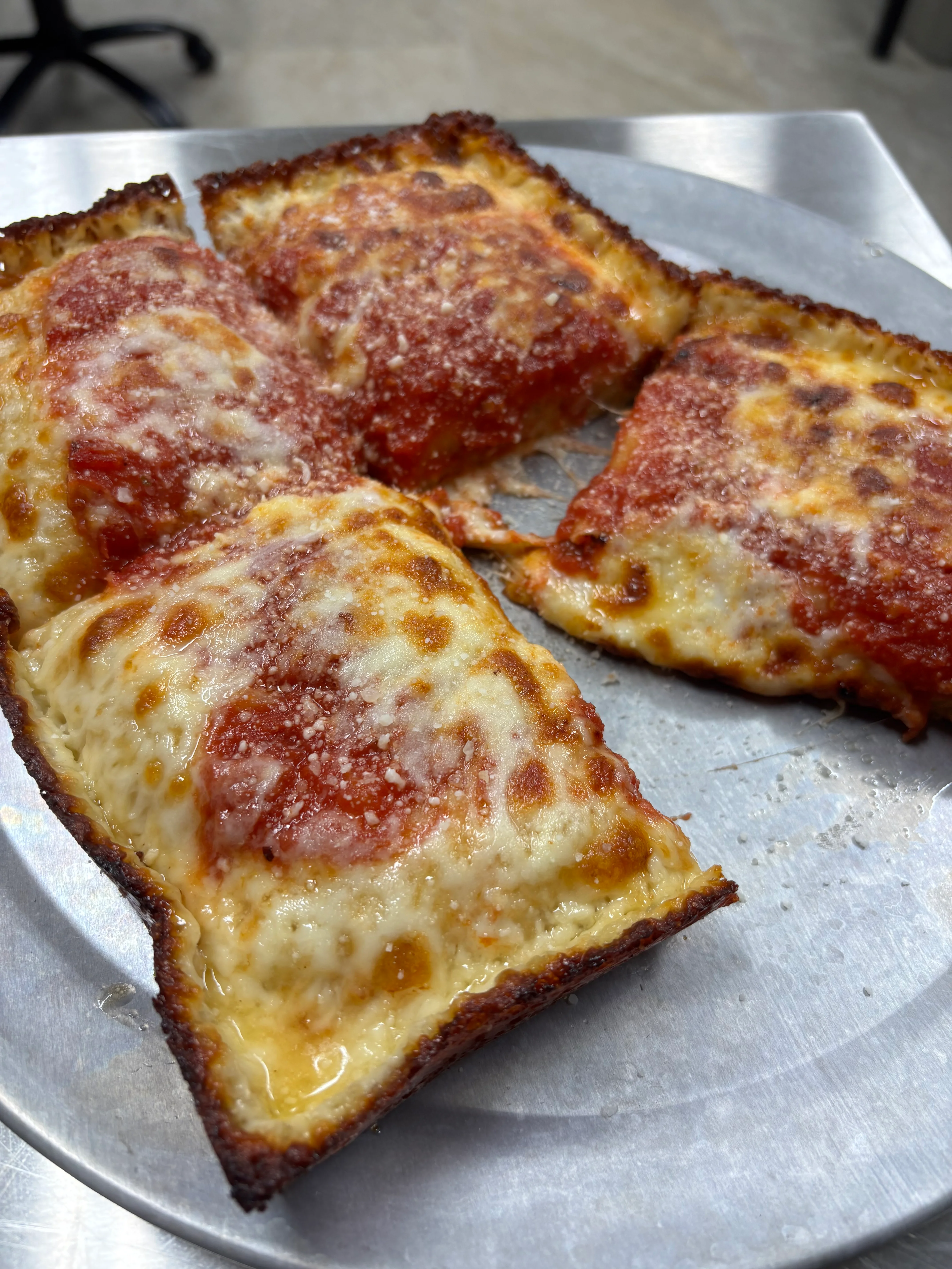Sicilian-style pizza with crispy crust and marinara sauce